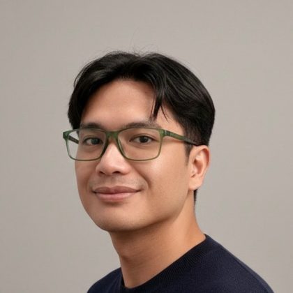 Dr Yamar smiles at the camera. He has short dark hair and is wearing glasses