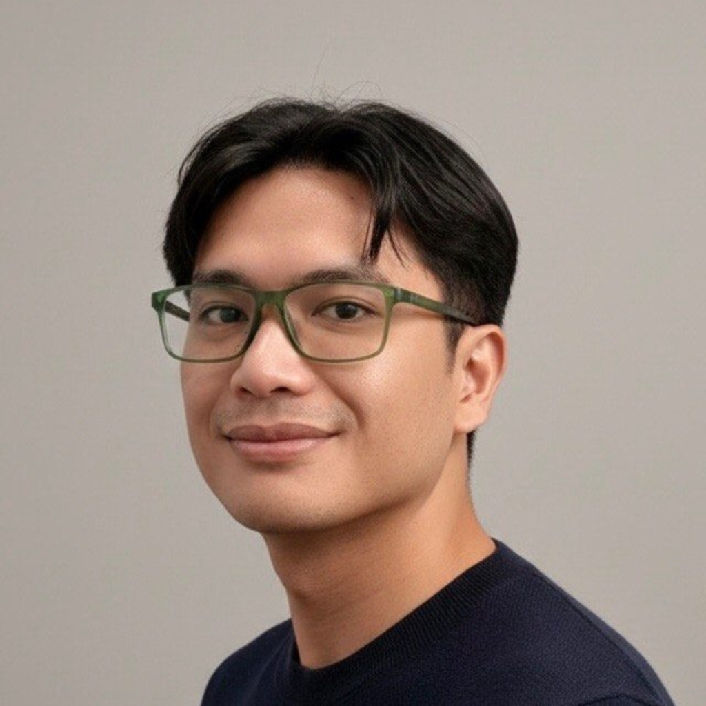 Dr Yamar smiles at the camera. He has short dark hair and is wearing glasses